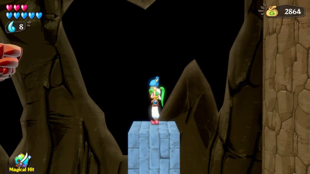The player in a cave environment standing atop a blue brick cube