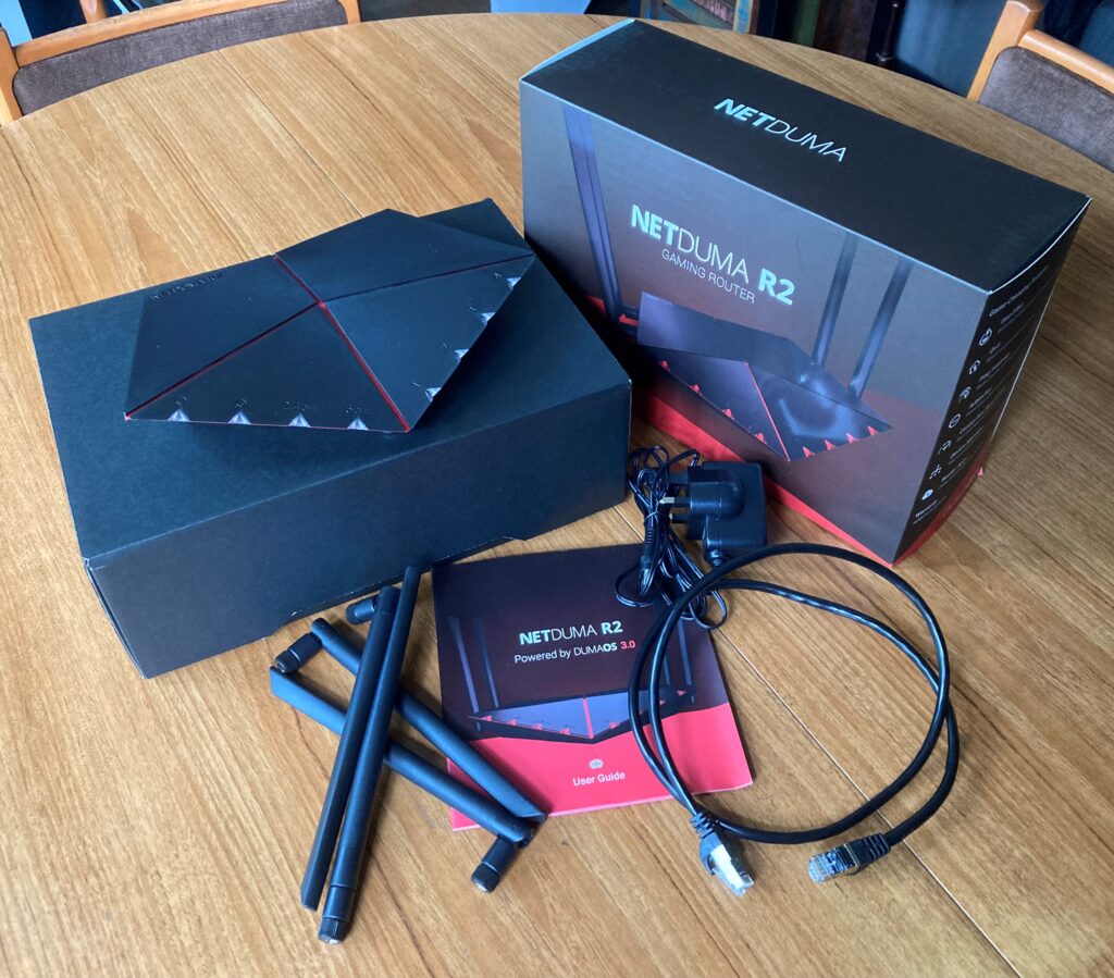 The Netduma R2 Gaming Router, user guide, t=ehternet cable, antennae, plug and box