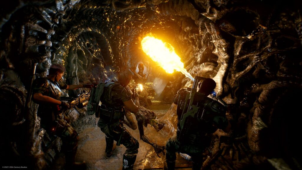 Three space marines use flamethrowers to burn the hallway of a xenomorph nest.