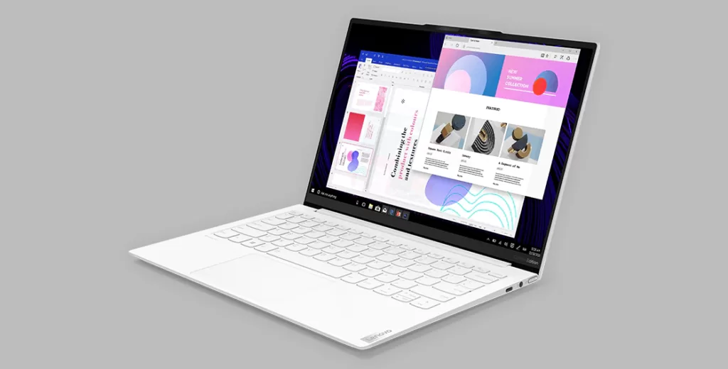 The Yoga Slim 7i facing to the left on a grey background, with multiple tabs open on the screen.