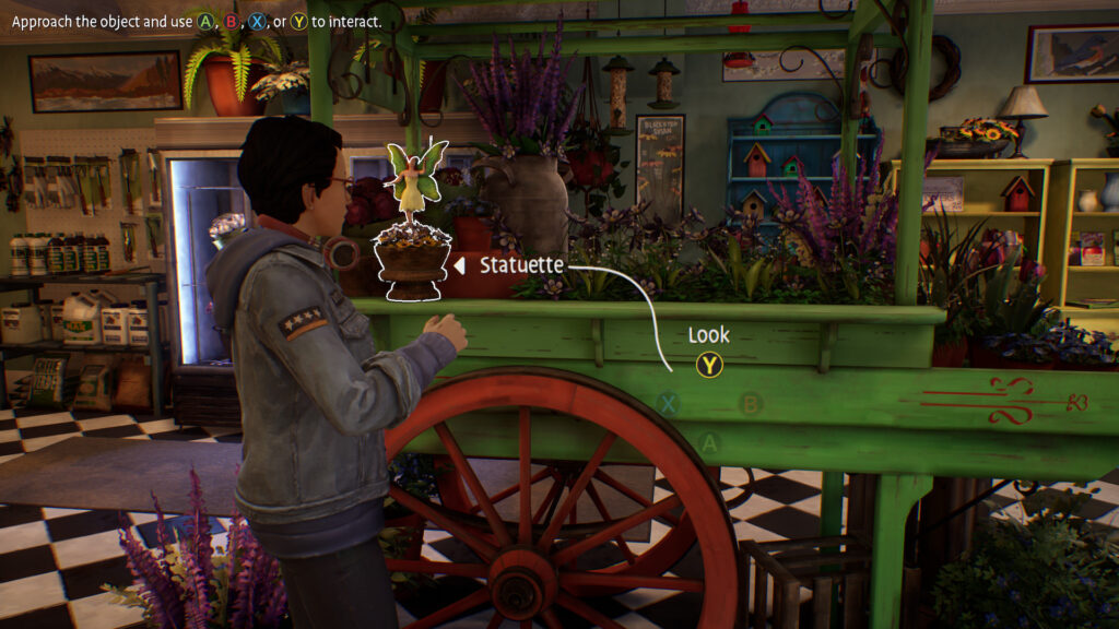 A statue is highlighted by a white outline, with an arrow pointing towards it with the Y button for the Look action.