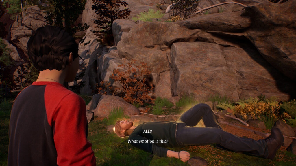 Alex looks at Ryan lying on the floor who has a golden aura around him.