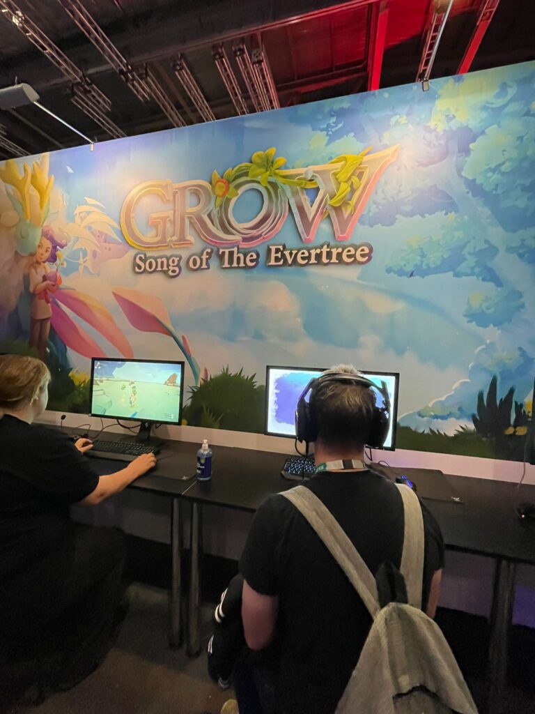 People playing Grow: Song of the Evertree on PCs at its EGX booth.