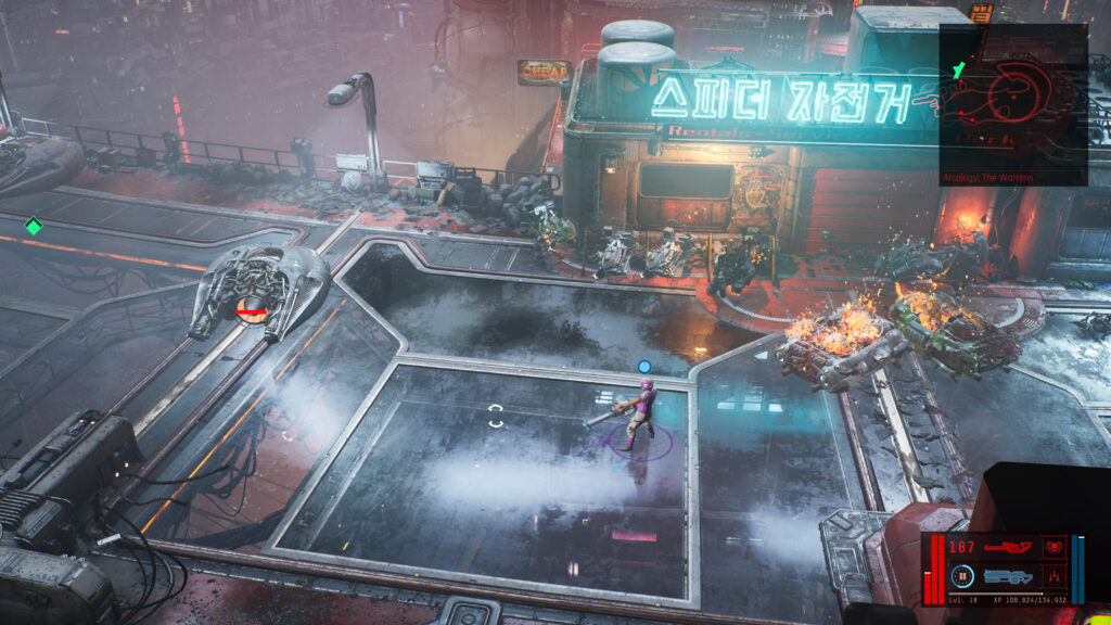 A street scene in The Ascent video game. My character stand in the middle of the street surrounded by burning futuristic vehicles and a dilapidated building.