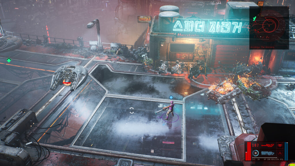 A street scene in The Ascent video game. My character stand in the middle of the street surrounded by burning futuristic vehicles and a dilapidated building.
