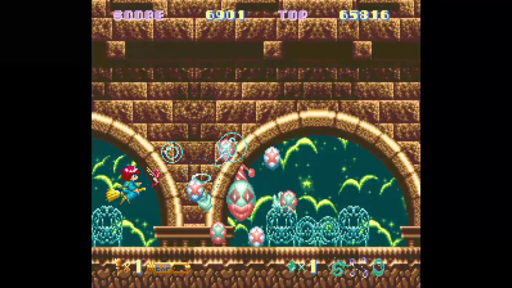 Cotton riding around fighting a clow-like boss in a visually distinct setting