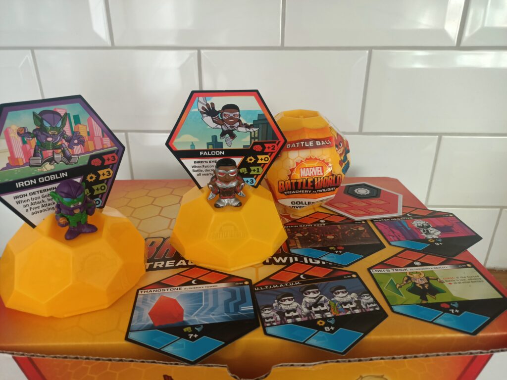 A hexagonal sphere with Falcon and Iron Goblin figures