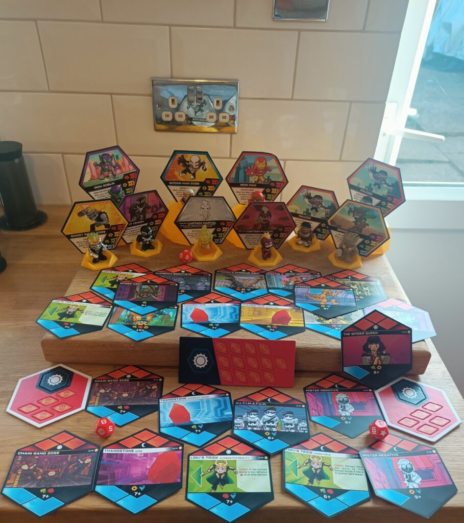 Plastic figures of various marvel characters and hexagonal paper pieces.