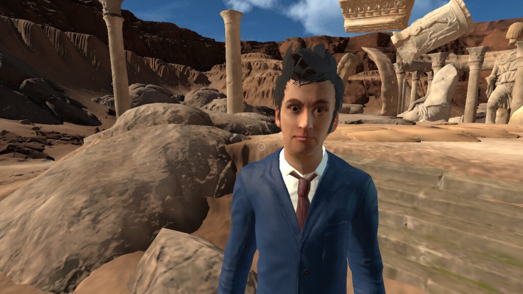 The Tenth Doctor stands in front of crumbling stone ruins.