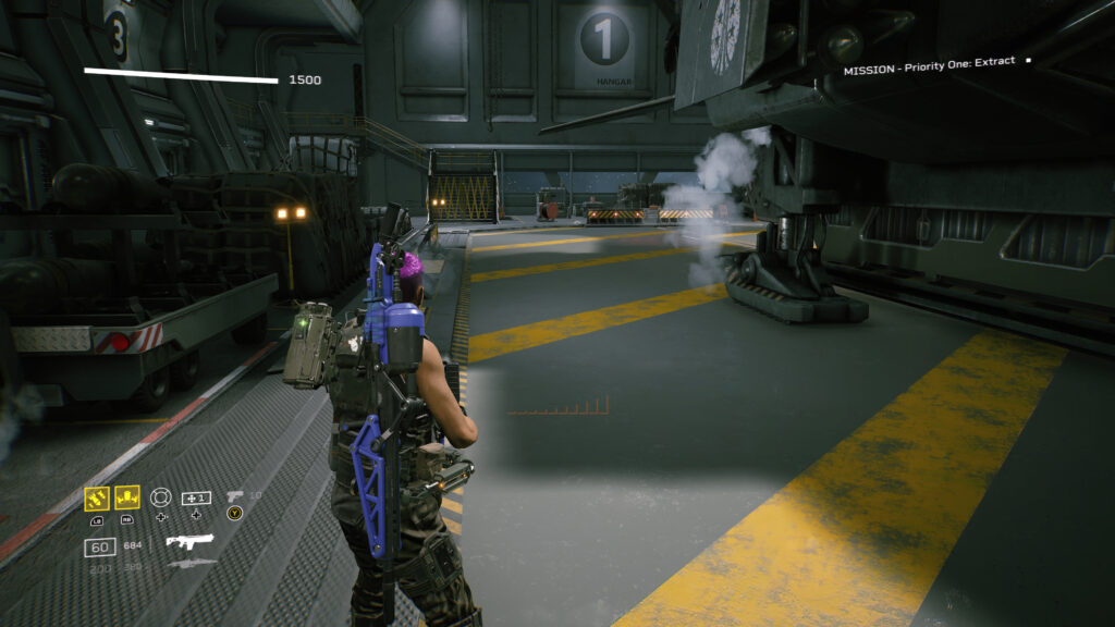 A Colonial Marine stands in the centre of a hangar with a dropship to the right.
