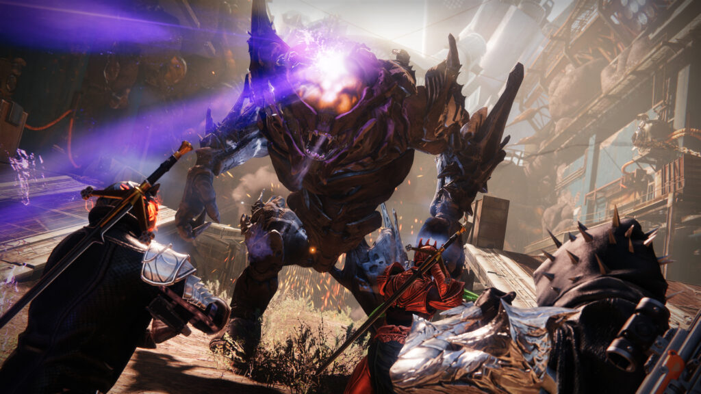 3 players charge a giant armoured monster shooting lasers from its eye.