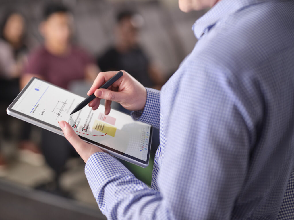 Man holding a Surface and a Surface Pen