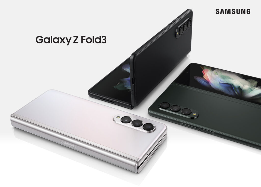 Samsung Galaxy Z Fold3 promotional image. A phone lays on a white surface, half shows the screen, the other half is vertical.