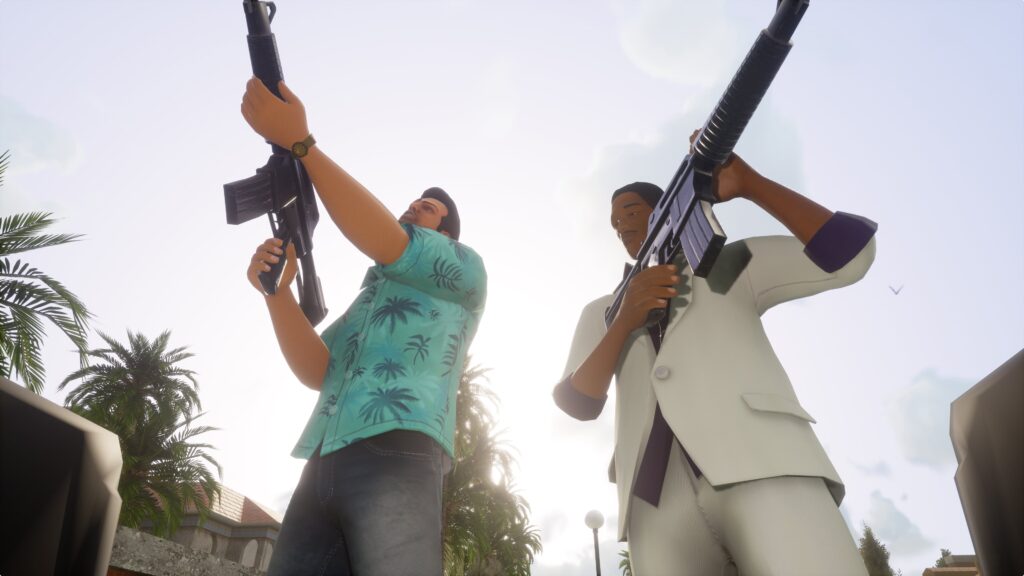 The male protagonist and a male NPC hold up large assault rifles to the sky.
Grand Theft Auto: The Trilogy - The Definitive Edition Review