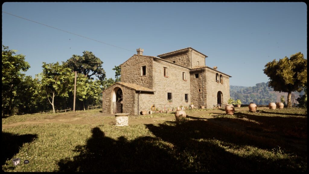 A stone building surrounded by grass and trees in the Italian countryside