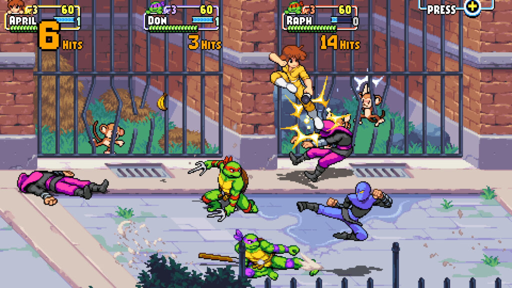 April, Michelangelo and Donatello battle members of the Foot Clan in front of cages with small monkeys behind the bars