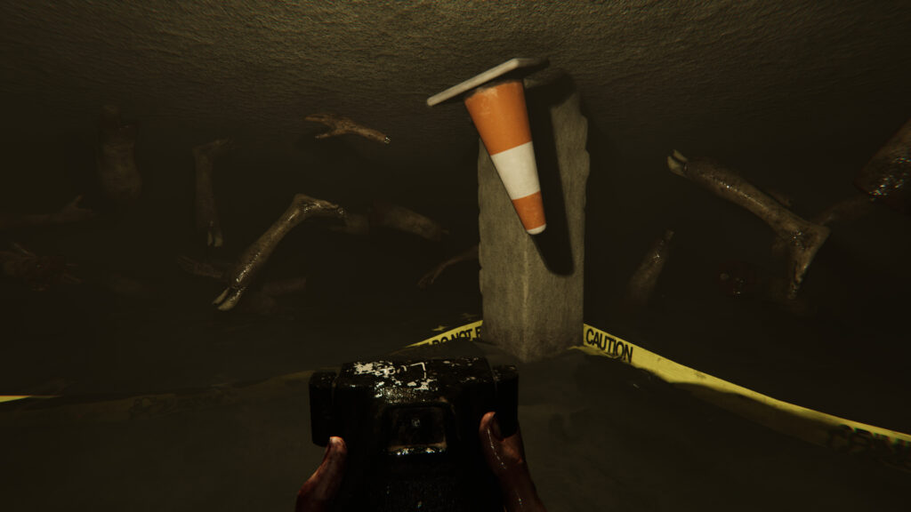 An underground room filled with severed legs and a traffic cone, as your character's hands hold a camera.
