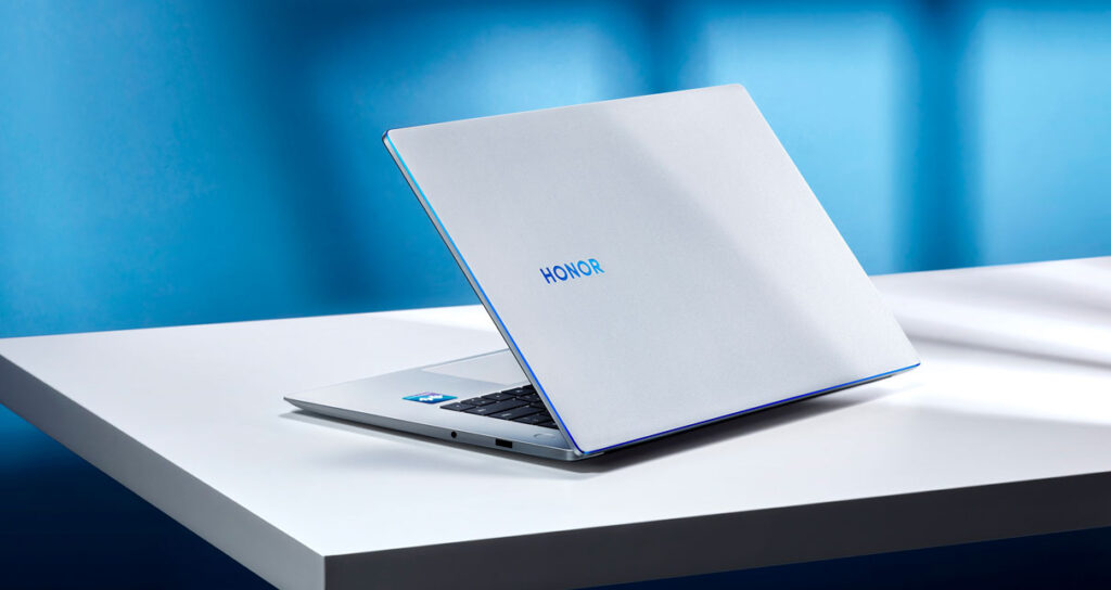 The Honor MagicBook15 viewed open from an angle, showing part of the keyboard