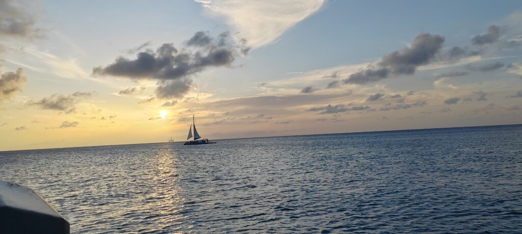 a boat sails on the sea in the distance