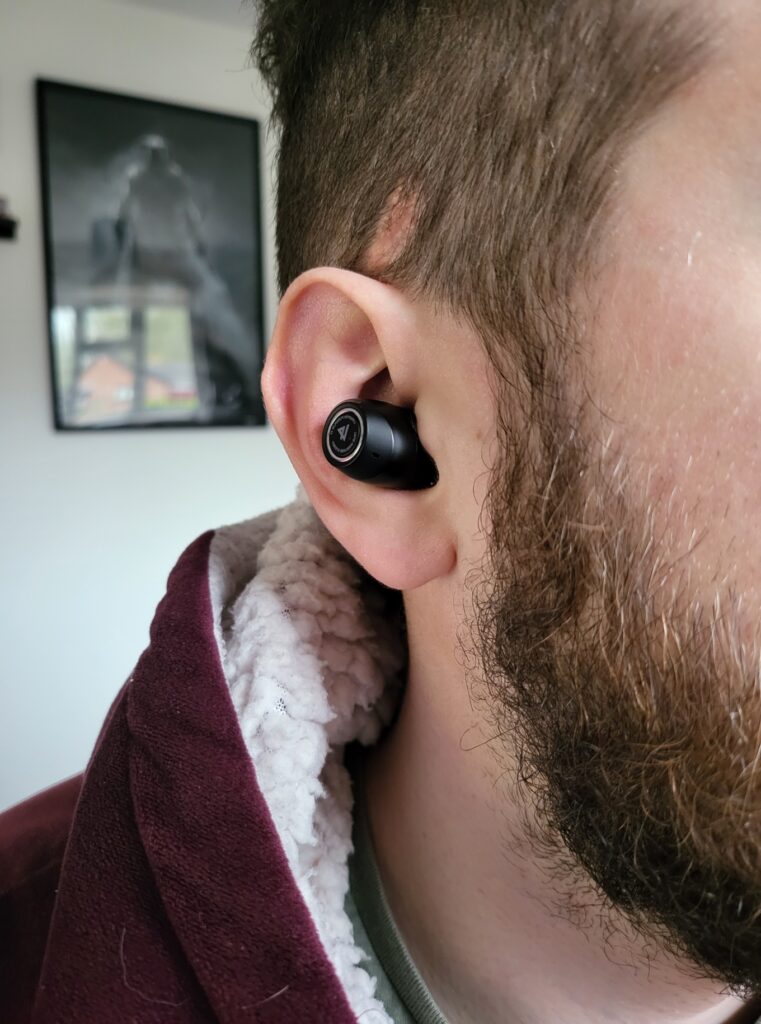 One of the Lypertek PUREPLAY Z7 earphones being worn.