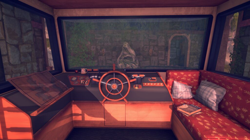 the interior of a boat showing the cockpit in the middle, a map on the left and a soft seat on the right, a stone statue can be seen through the window
