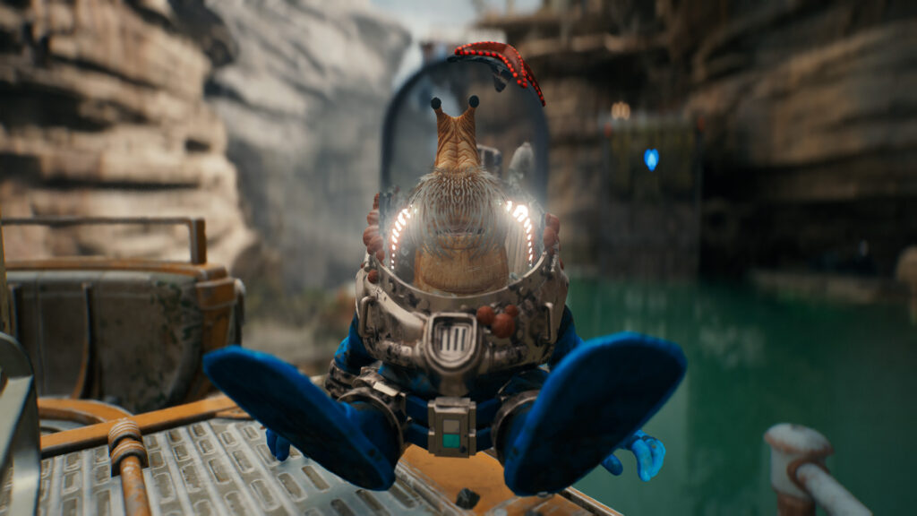 A snail-like alien inside a scuba suit with a starfish on his helmet sits by the water