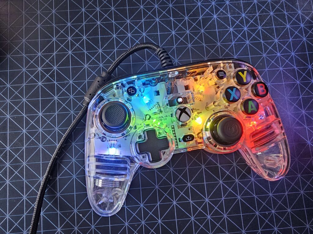 The Nacon Pro Compact Controller Colorlight with several different colours lit up