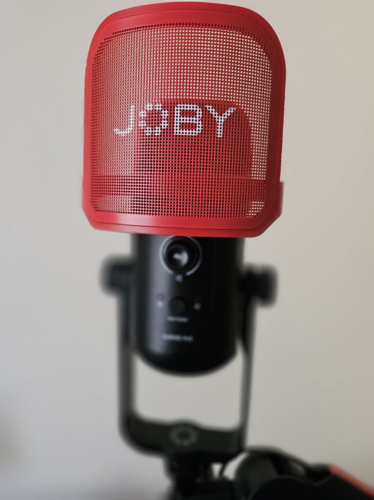 Front-on picture of the Wavo POD microphone with the pop filter attached, also showing the gain control and input button