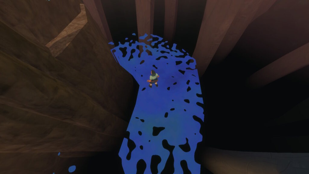 from an aerial view, a character walks on a path between rock faces