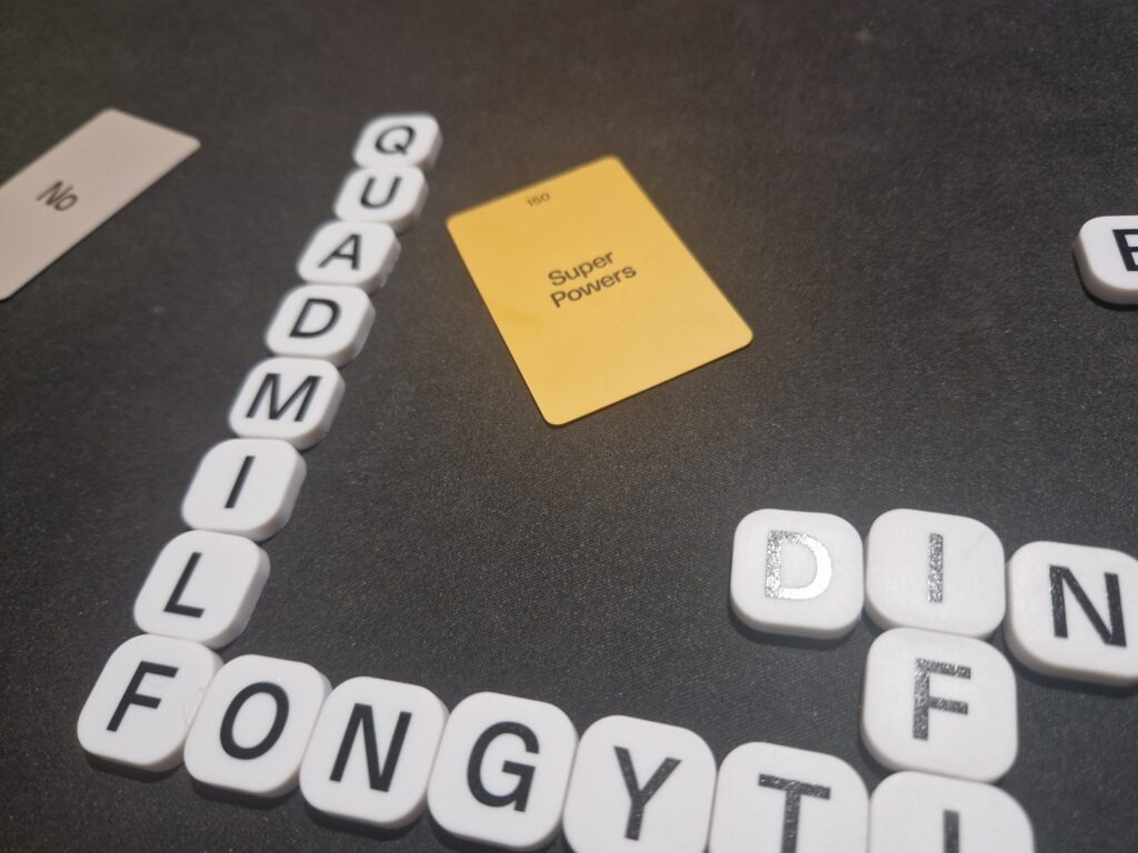 Blabbi rubber cubes making made up words with Blabbi cards placed around them