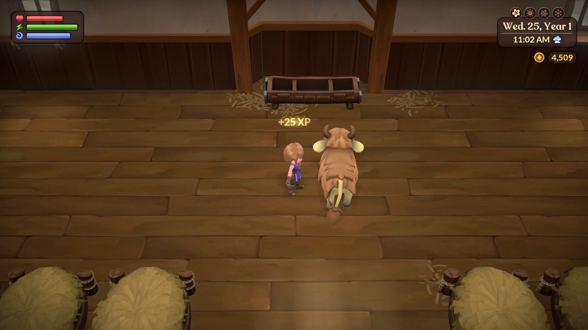 The main character standing next to a Mamoo, a cow-like creature, in a barn