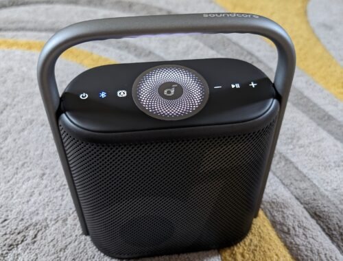 A picture of the SoundCore Motion X500 in a living room on a rug.