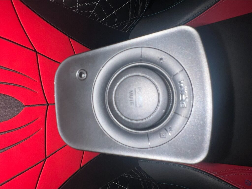 A close up photograph of the Power / Mute button and volume dial on the Sound Blaster GS3 sound bar.
