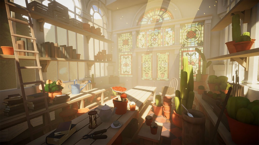An indoor greenhouse with a large bench in the middle. This bench is adorned with various plants and tools. A large selection of cacti plants sit on the right.