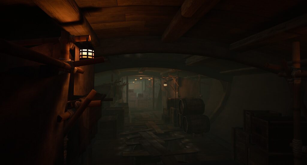 A dimly lit galley of the pirate ship is adorned with barrels, wooden crates, and other material needed for the battle ahead.